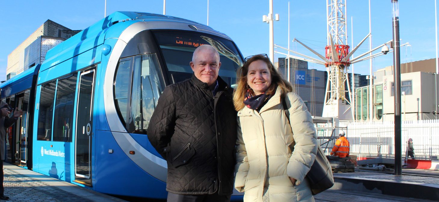Man and woman standing in front of tram